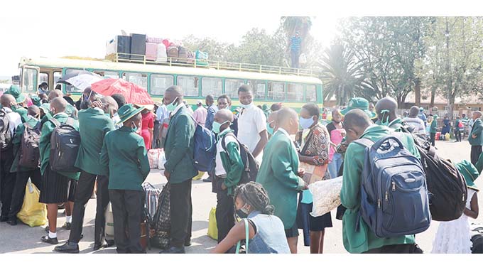 School children board buses to school